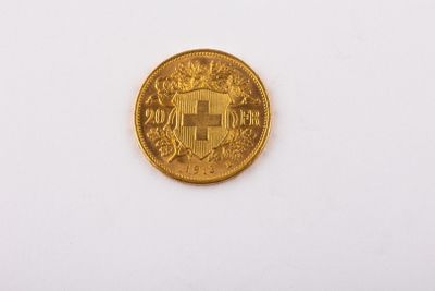a close up of a gold coin on a white surface