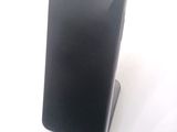 a cell phone that is on a stand on a table