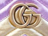 purple and gold quilted purse with a double g buckle