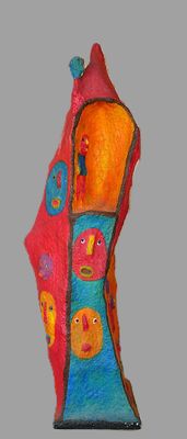 a colorful sculpture of a house with a bird on top of it