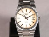 a silver watch with a white face on a black stand