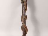 an old wooden stick with a carved handle on a white background