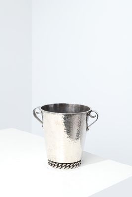 a silver bucket sitting on top of a white shelf