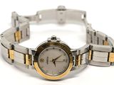 a silver and gold wrist watch on a white surface