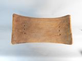 an old wooden tray with holes in it on a white surface