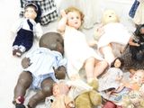 a lot of dolls that are sitting on the floor