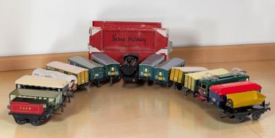 many toy trains that are sitting on the floor