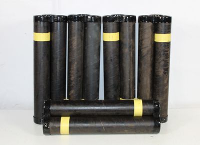 four black and yellow cylinders are stacked on top of each other