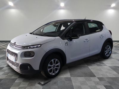 the white citrole is parked on a checkered tile floor