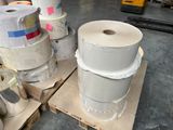 several rolls of toilet paper sitting on top of a pallet in a warehouse