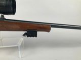 a close up of a rifle with a scope mounted on it