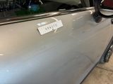 a silver car with a sticker on the side of it
