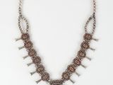the necklace is made of silver and brown stones