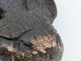 a close up of a piece of wood with a face on it