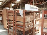 many stacks of wood in a warehouse with a white box on top of them