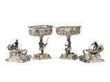 three silver plated candlesticks with figures on them