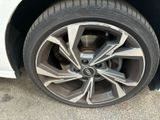 a close up of a tire on a white car