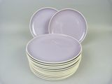 purple plates stacked on top of each other on a table