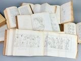 several open books with drawings on them on a blue surface