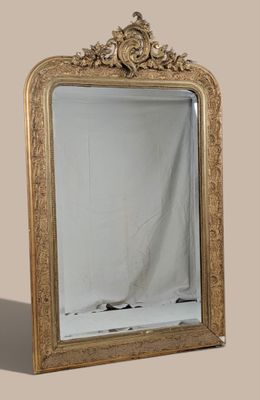 a mirror that is sitting on the floor in front of a wall