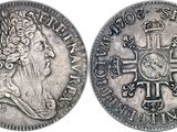 a silver coin with a cross on the front and a crown on the back
