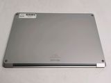 the back of a silver laptop computer sitting on top of a white table
