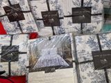 a lot of white and blue bedding on a table