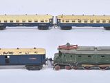 quatre petits trains sont alignés les uns à côté des autres sur une surface blanche