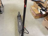 a scooter that is sitting on the floor in a room