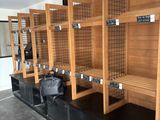 a lot of wooden shelves with bags on them