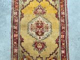 a yellow and red rug sitting on top of a blue floor