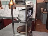 stainless steel counter top in a restaurant kitchen with plates stacked on it