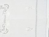a white table cloth with a monogram on it