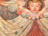 an image of a close up of a carved angel on a wall