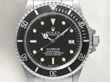 a close up of a watch with a black dial on a bracelet
