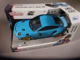 a blue toy car in a box on a table