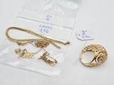 two rings, a necklace, and a bracelet are sitting on a table