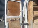 a white van with a door open in a parking lot