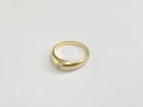 a close up of a gold ring on a white surface