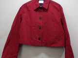 a red jacket hanging on a hanger in a room