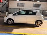 a small white car parked in a parking lot