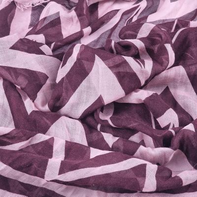 a close up of a purple and white chevroned scarf
