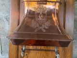 a wooden wall mounted mailbox with a bell on it