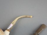 a pipe and a pipe holder sitting on a table
