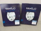 two boxes of saniloo soap sitting on a table