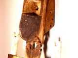 a wooden sculpture of a bird that is on a stand
