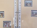 a picture of a bathroom with a toilet and pictures on the wall