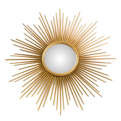a gold sunburst mirror on a white wall