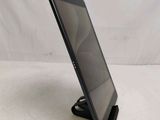 a tablet computer sitting on top of a stand on top of a table