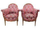 pair of red and white upholstered chairs on wooden legs